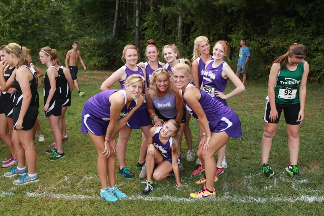 Jennifer seen here with one of her Cross-Country Teams (Catie Byrd, her daughter in front on the left is now an 11-time All-American at Queen's University in Charlotte).